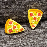 Two silicone stitch stoppers in the shape of triangular slices of pizza.  The pizza is topped with tomatoes, and basil. 