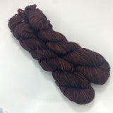 Two miniskeins of deep rich tonal brown yarn. 