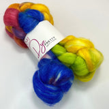 A braid of dyed wool top is cinched at the middle in a white label reading Dye Pretty Yarn + Fibre.  The fibre is dyed bright pink, bright orange, neon yellow, neon green, and royal blue and the braid sits atop a white background.