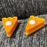 Two silicone stitch stoppers in the shape of slices of pumpkin pie.