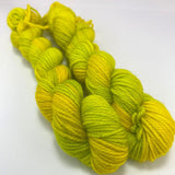 Two mini skeins of an acidy neon green and yellow variegated yarn. 