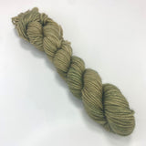 A mini skein of pistachio green yarn. 