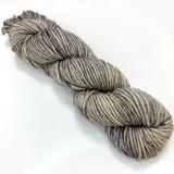 One mini skein of light grey tonal worsted weight yarn. 