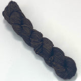 One mini skein of rich charcoal yarn.