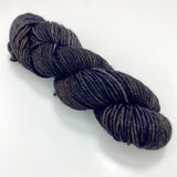 One mini skein of deep charcoal tonal worsted weight yarn. 