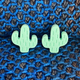 Two silicone stitch stoppers in the shape of cacti.  Mint green in colour.